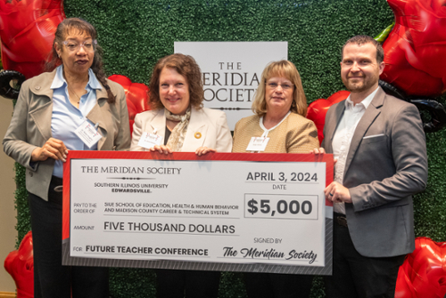 Robin Hughes and three representatives from the SEHHB holding a check from the Meridian Society