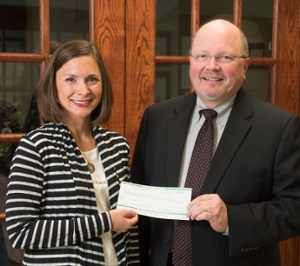 Dr. Michelle Pavlak-Hawkins presents Dr. Bruce Rotter, dean of the SIU SDM, with a check for the scholarship endowment.
