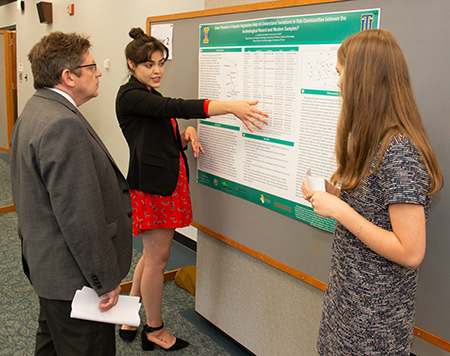 REU participant Laura Ruiz, a senior anthropology major at the University of Tulsa shares her team’s findings with SIUE Associate Provost for Research and Dean of the Graduate School Jerry Weinberg, PhD.