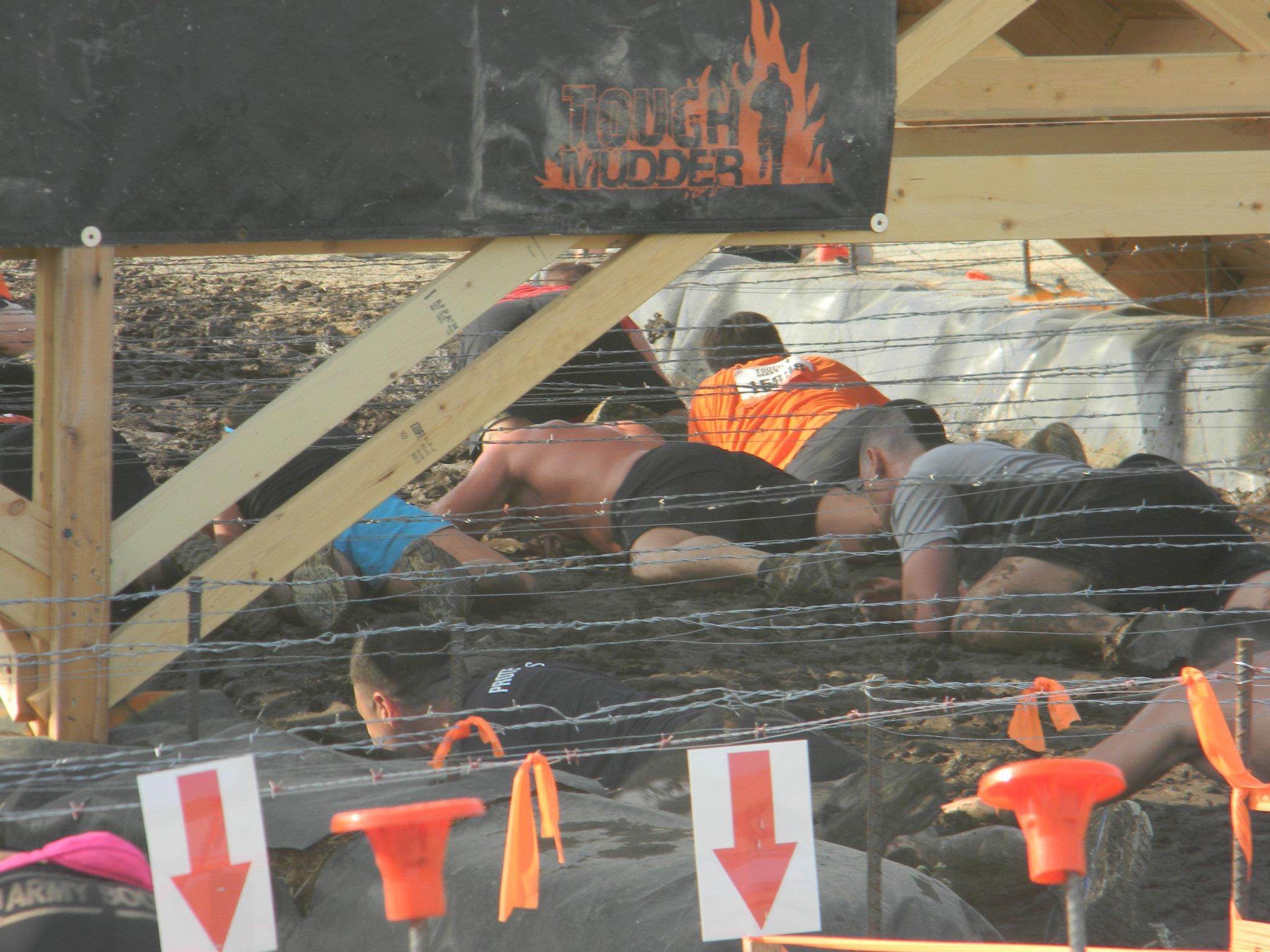 racers crawling under barbed wire