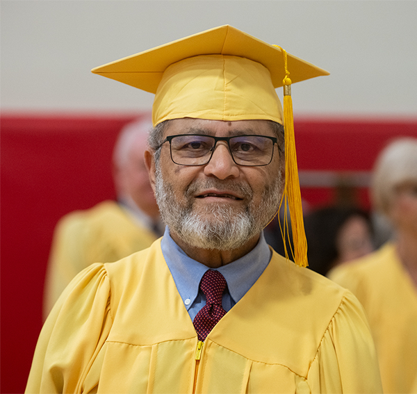 Golden graduate Obaid Naveed Siddiqi in his cap and gown