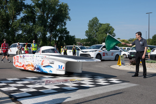 Solar car waits as Dean Karacal waves the green flag