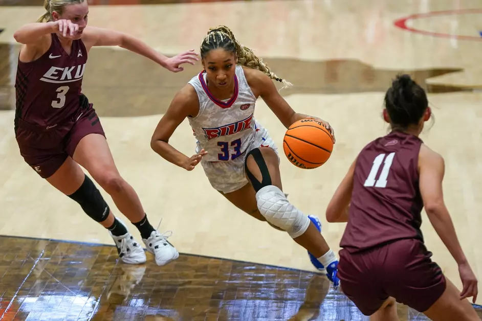 Three women playing basketball