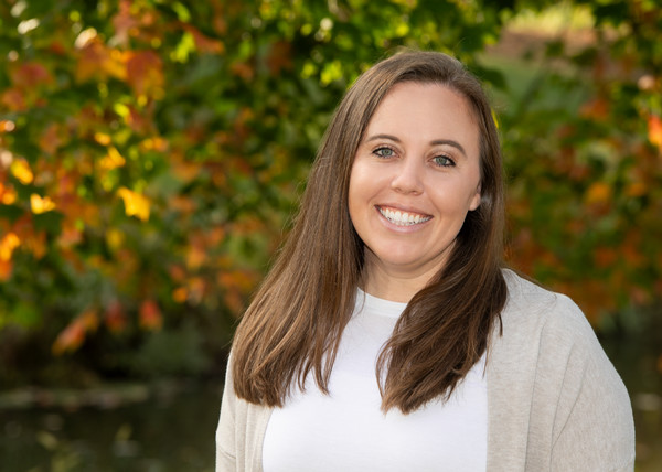 Portrait of Sydney Greenwalt in front of leafy trees