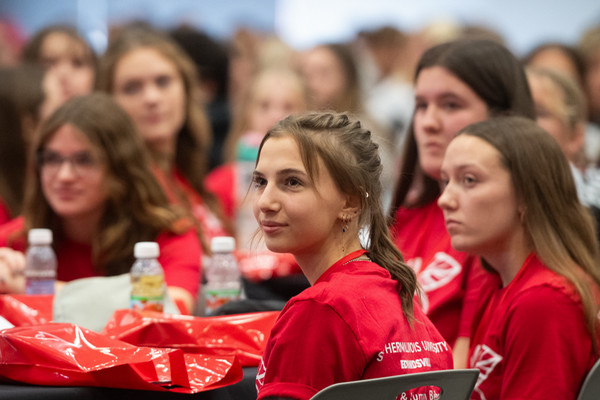 Girls at table listening to speaker off camera