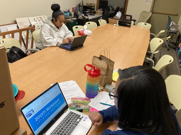 Two students studying at long table