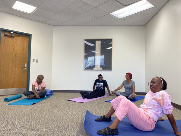 Yoga participants on mats in mindfulness room