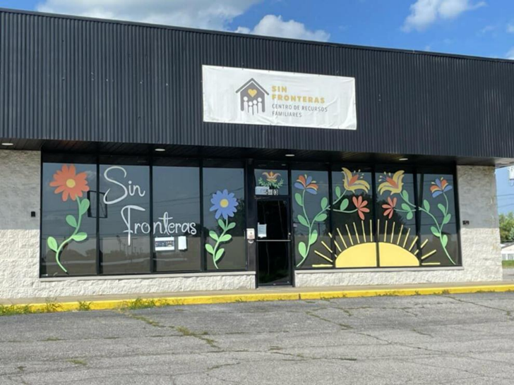 Exterior view of the Sin Fronteras Centro de Recursos Familiares building with colorful floral window murals.