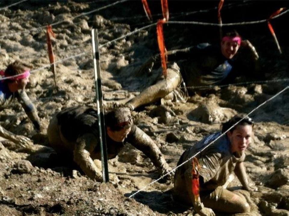 more racers crawling under barbed wire