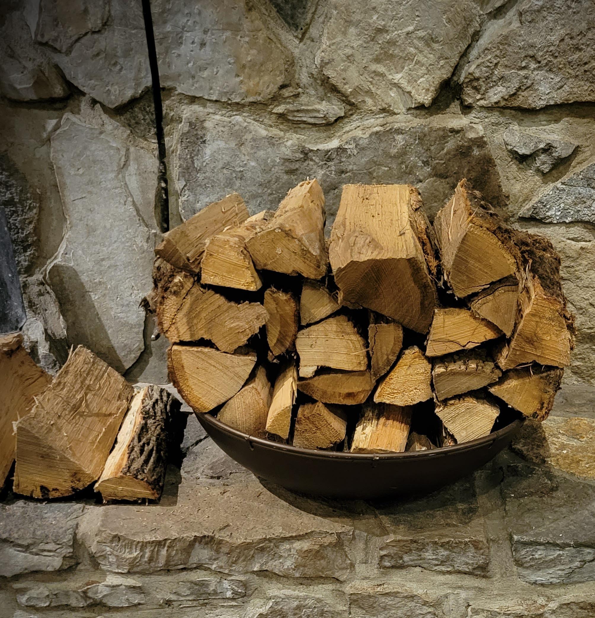 stack of seasoned wood next tp stone fireplace